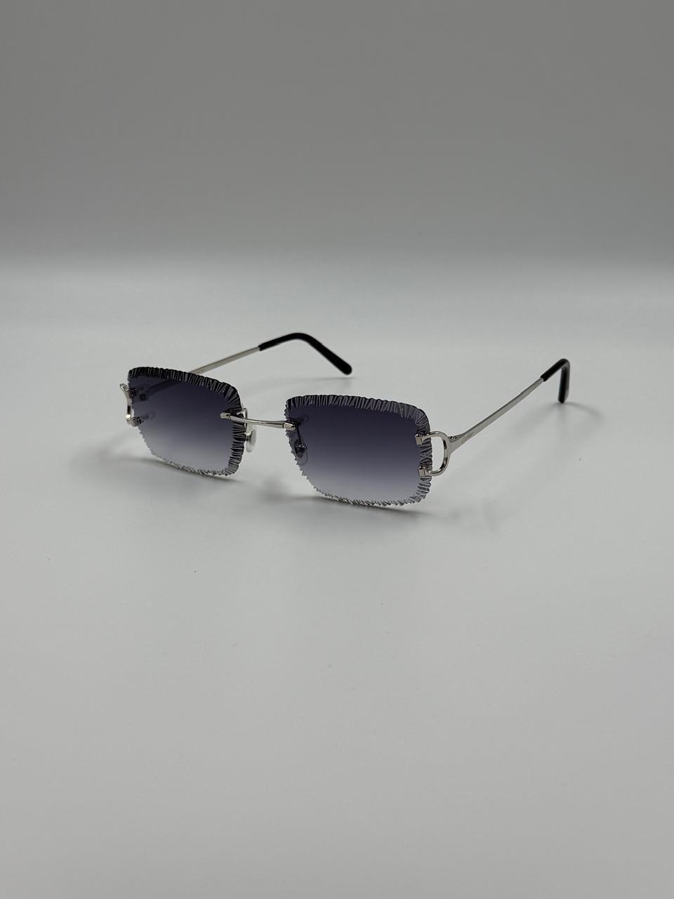 Dark sunglasses on a pale surface