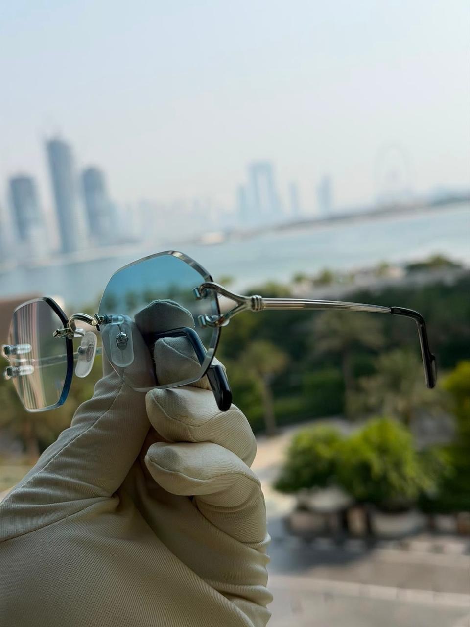 Sunglasses held in warm daylight