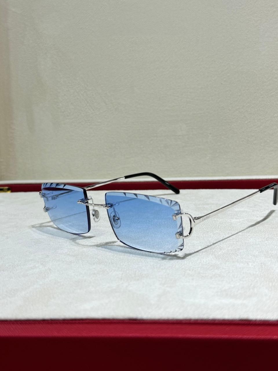 Blue-lensed rimless sunglasses