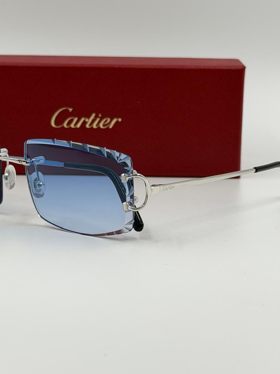 Blue-lensed eyewear beside a red presentation case