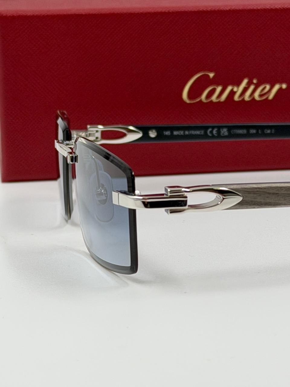 Sunglasses beside a red presentation box