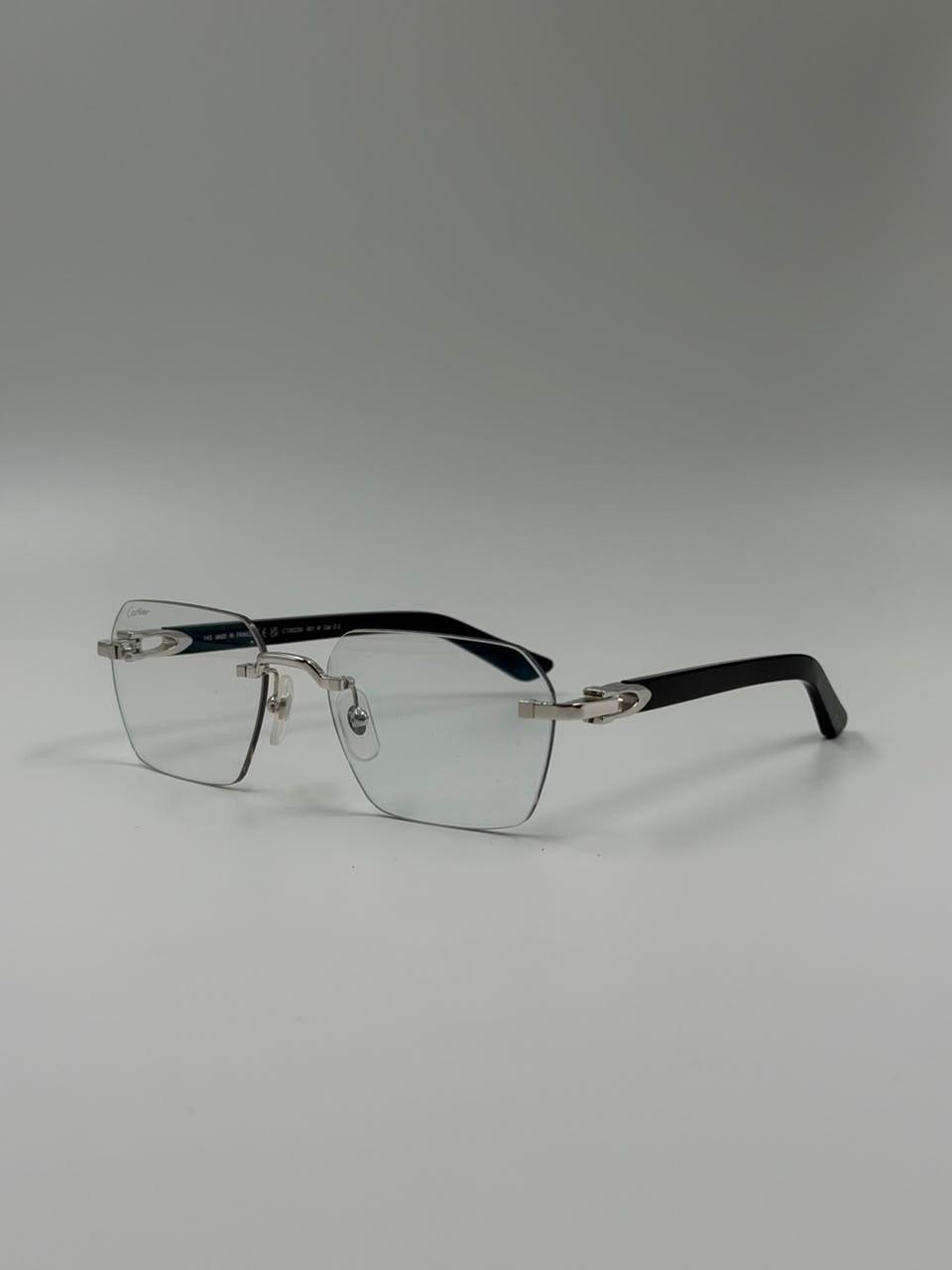 Fine-lined eyeglasses on a pale surface